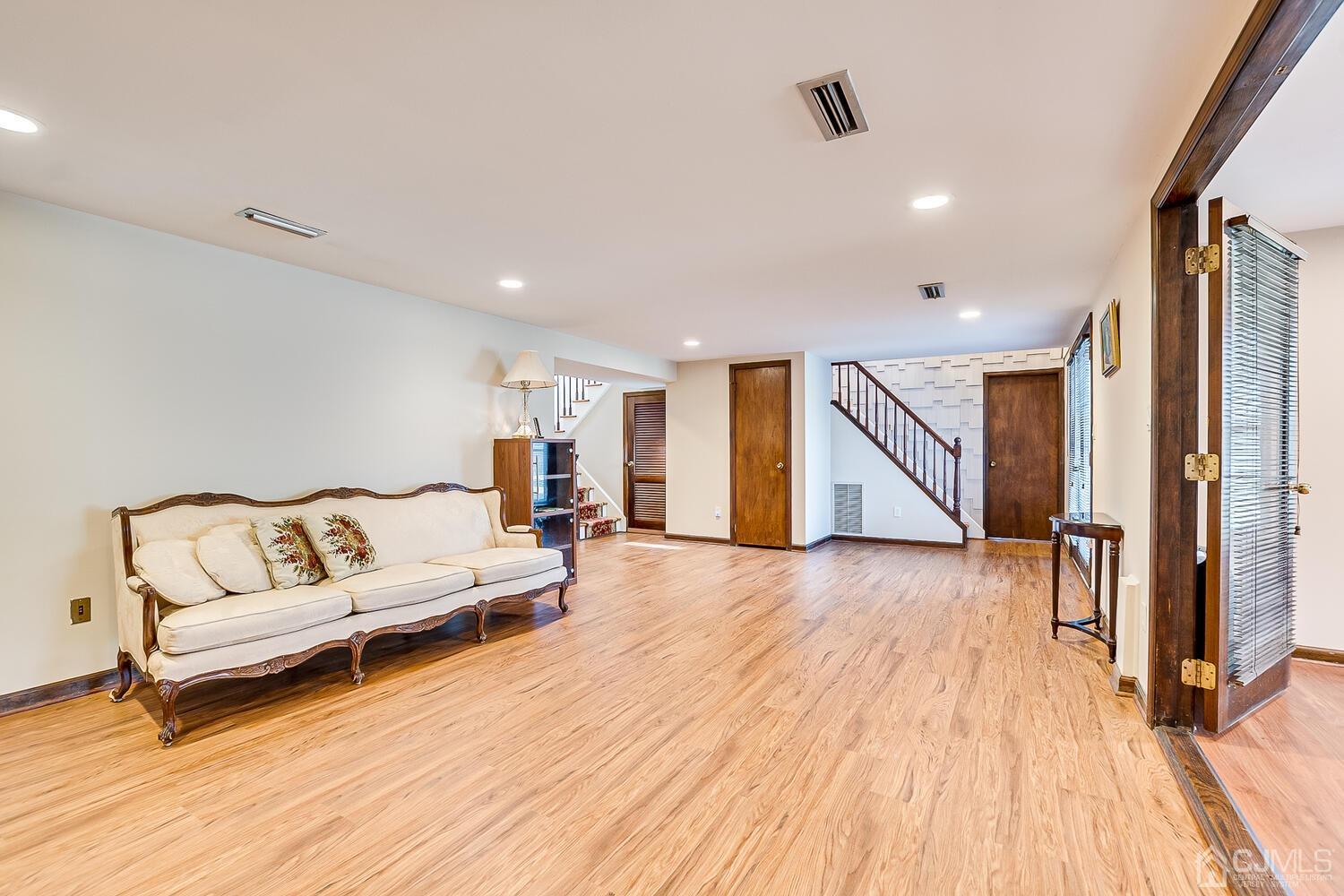 41 Clive Hills Road Edison, NJ 08820 - Photo 21 of 39 a spacious bedroom with a bed and a wooden floor