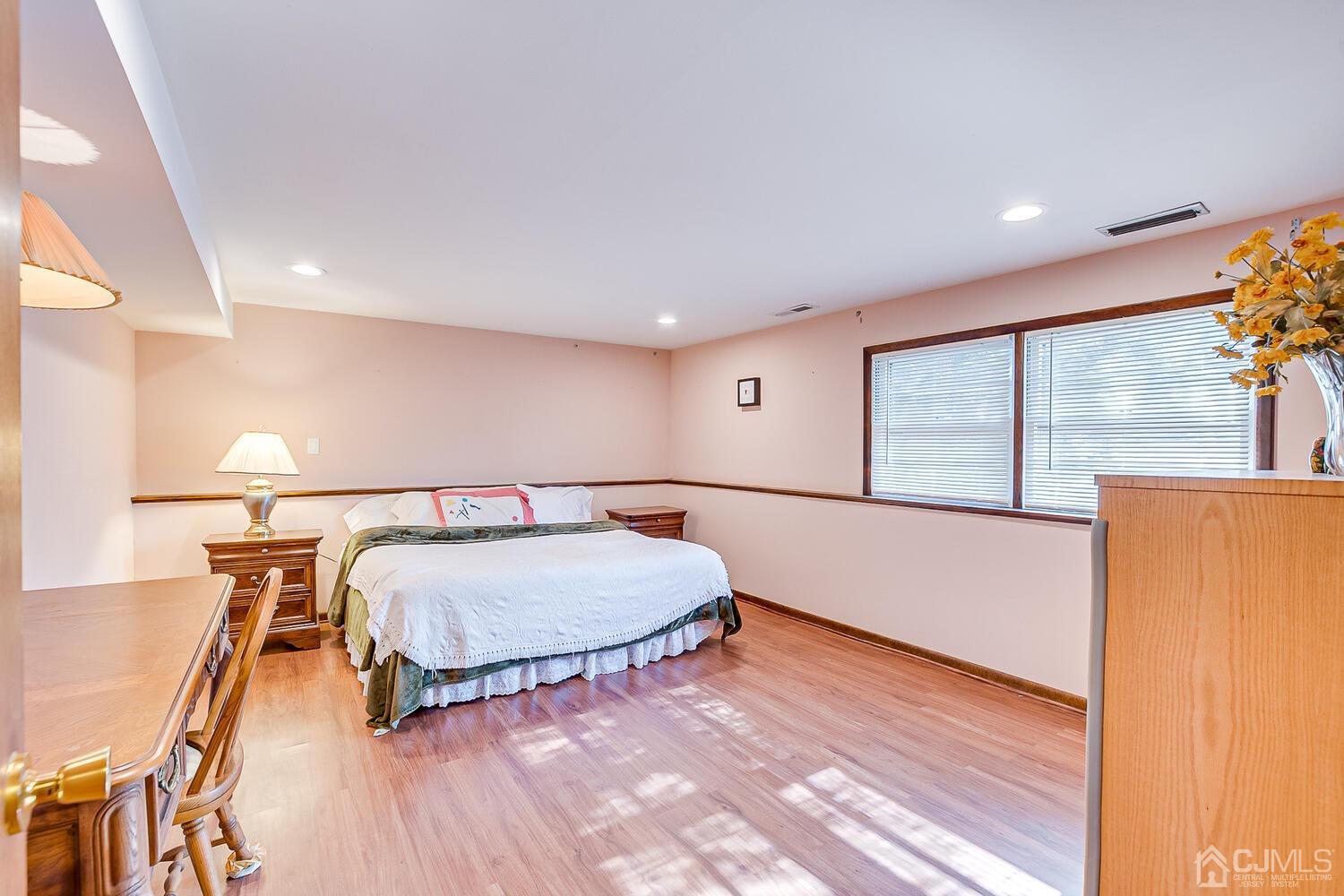 41 Clive Hills Road Edison, NJ 08820 - Photo 24 of 39 a living room with a balcony furniture and a wooden floor