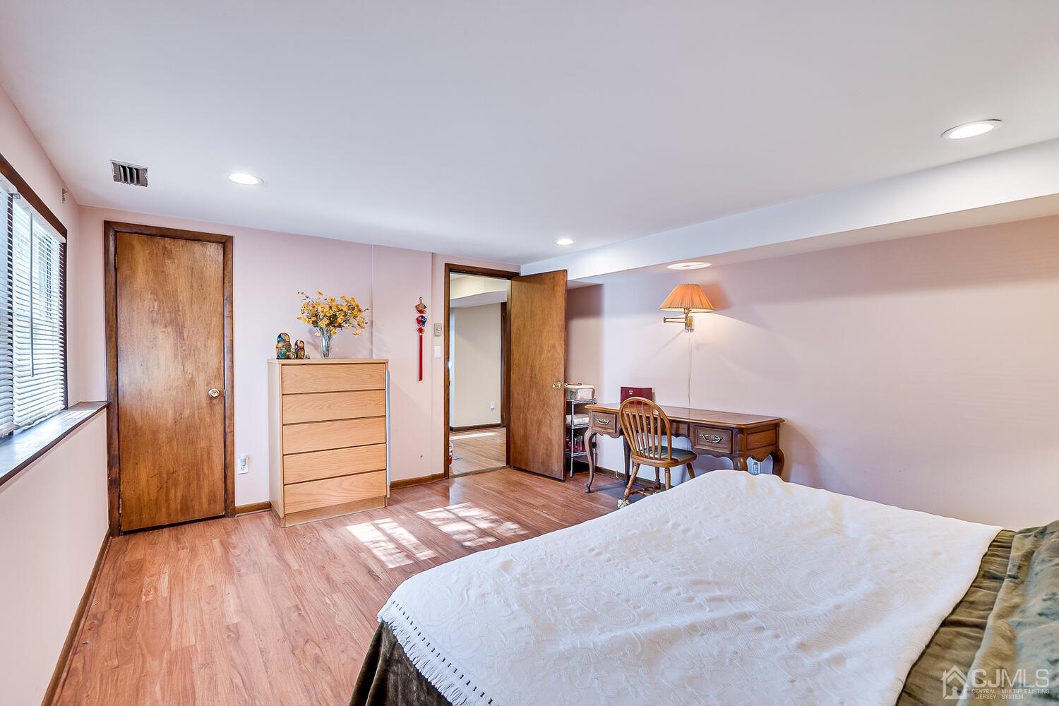 41 Clive Hills Road Edison, NJ 08820 - Photo 25 of 39 a bedroom with a bed and wooden floor