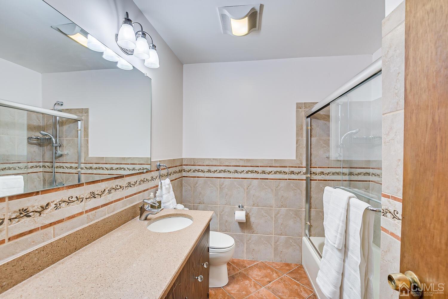 41 Clive Hills Road Edison, NJ 08820 - Photo 33 of 39 a bathroom with a double vanity sink a mirror and a shower