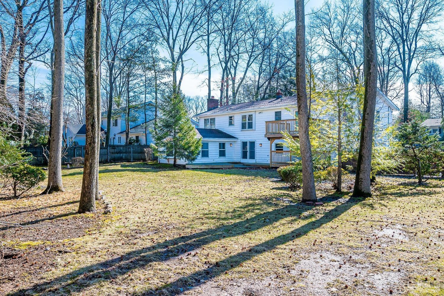 41 Clive Hills Road Edison, NJ 08820 - Photo 36 of 39 a view of a house with large trees and a yard