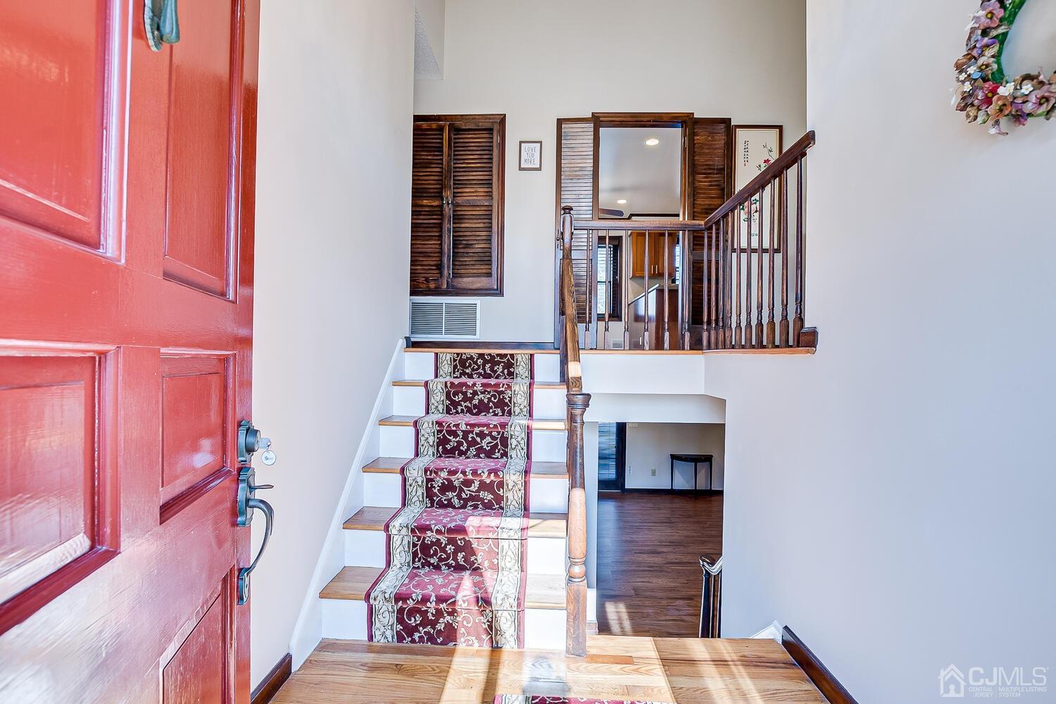 41 Clive Hills Road Edison, NJ 08820 - Photo 5 of 39 a hallway with a door and a potted plant