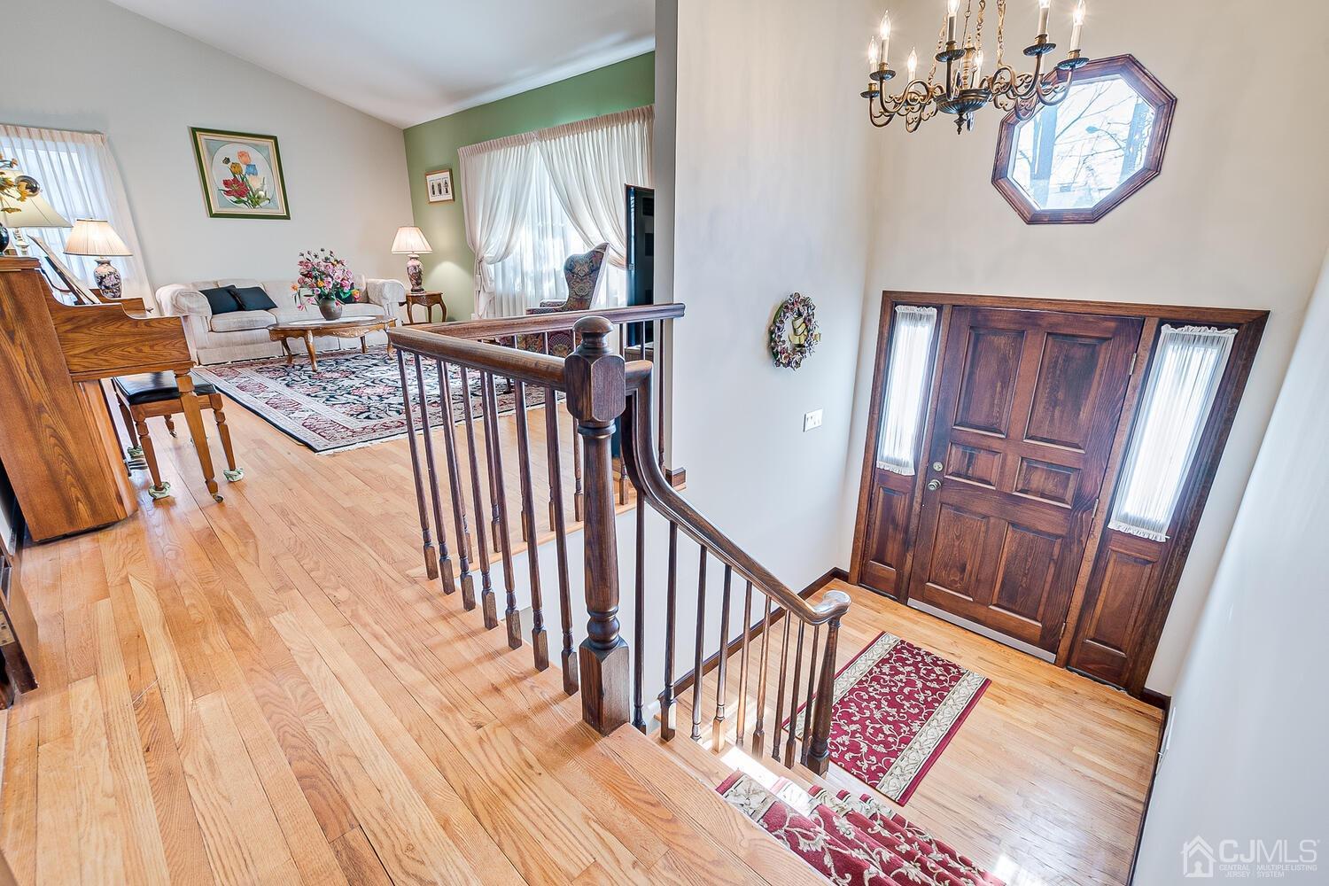 41 Clive Hills Road Edison, NJ 08820 - Photo 6 of 39 a view of a hallway with wooden floor and windows