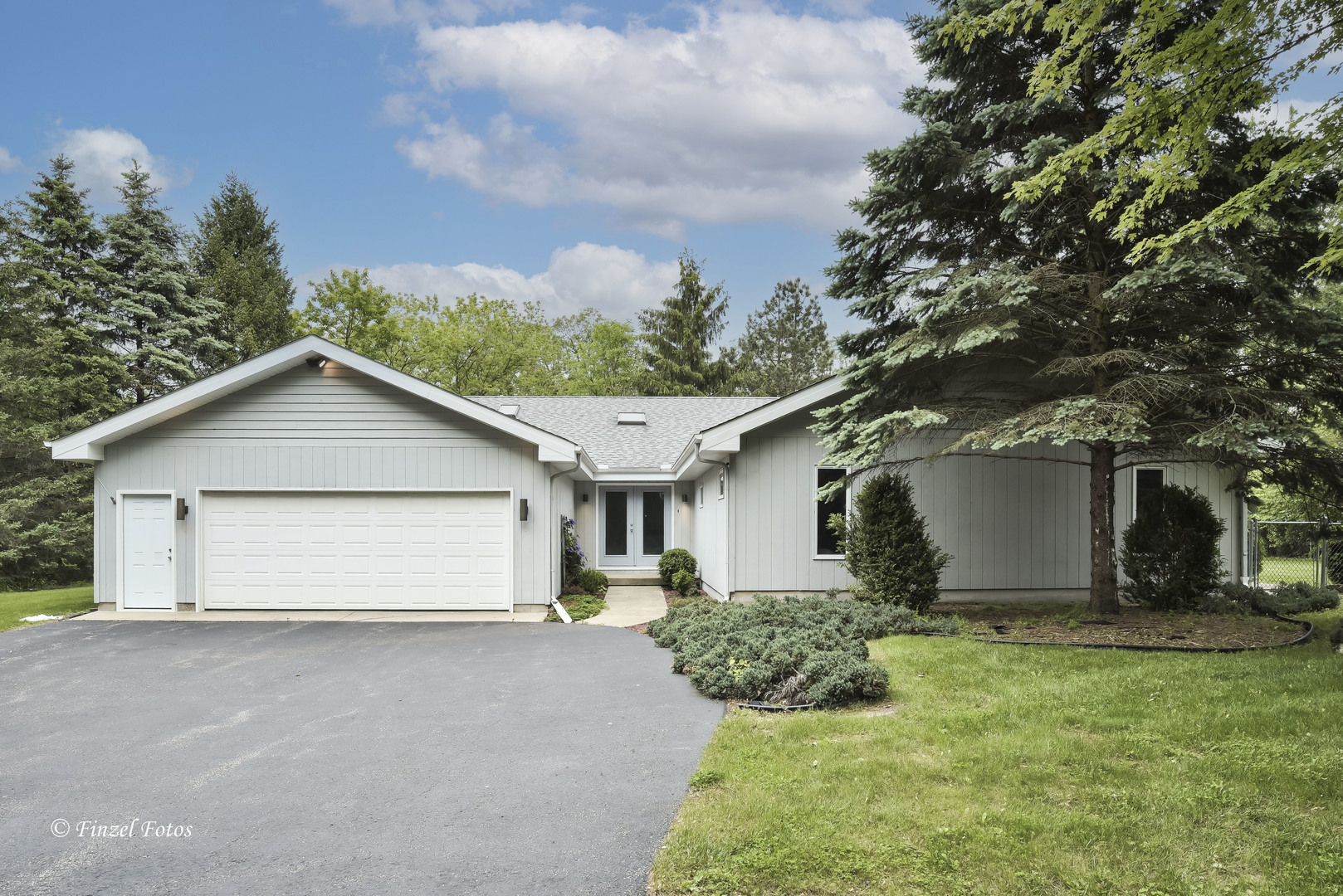 1817 Orchard Lane McHenry, IL 60050 - Photo 1 of 20 a view of a house with a yard and garage