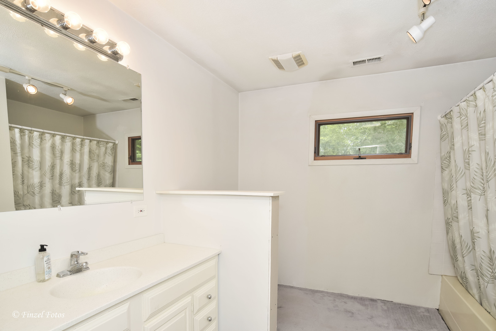1817 Orchard Lane McHenry, IL 60050 - Photo 16 of 20 a bathroom with a sink a window and a shower