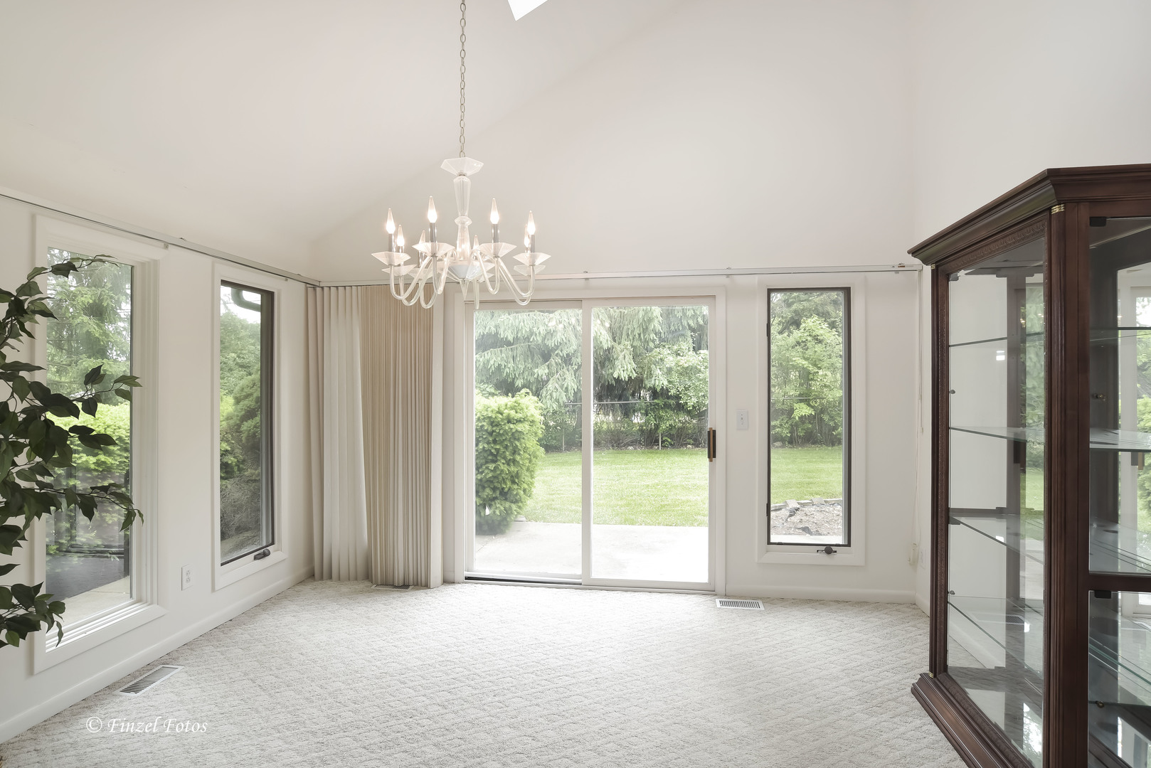1817 Orchard Lane McHenry, IL 60050 - Photo 8 of 20 a view of a big room with windows and chandelier