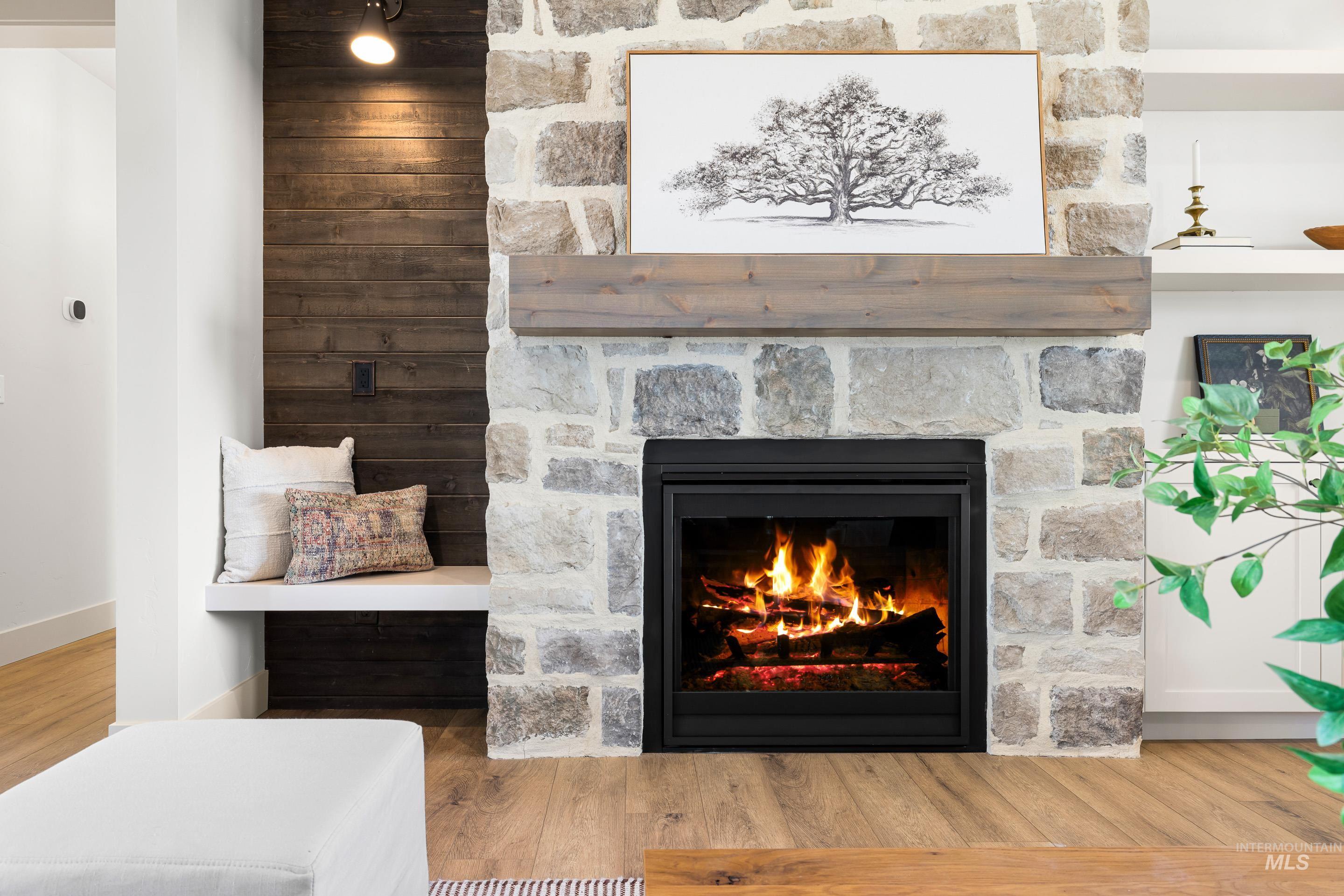 Detailed view of wood finished floors and a fireplace