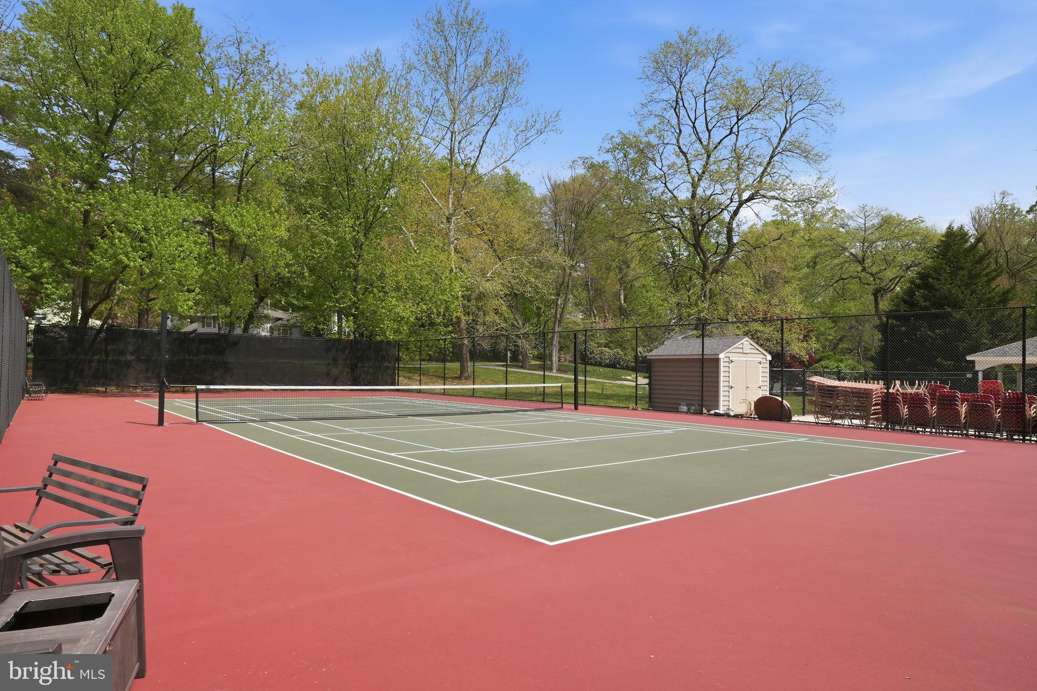 1567 Comanche Road Arnold, MD 21012 - Photo 66 of 67 Serene tennis court in lush greenery.