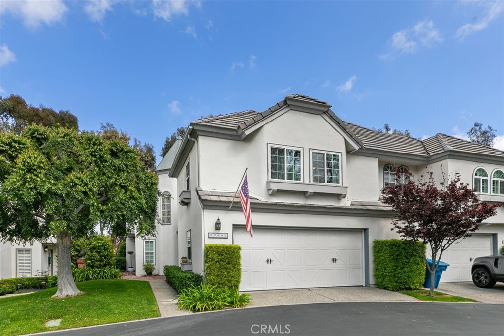 25496 Rue Terrase, Unit 22 Laguna Niguel, CA 92677 - Photo 1 of 1 a front view of a house with a garden and trees