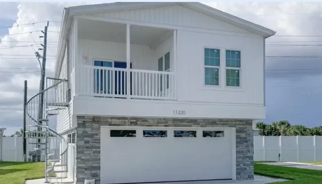 a view of a house with a tree in a yard