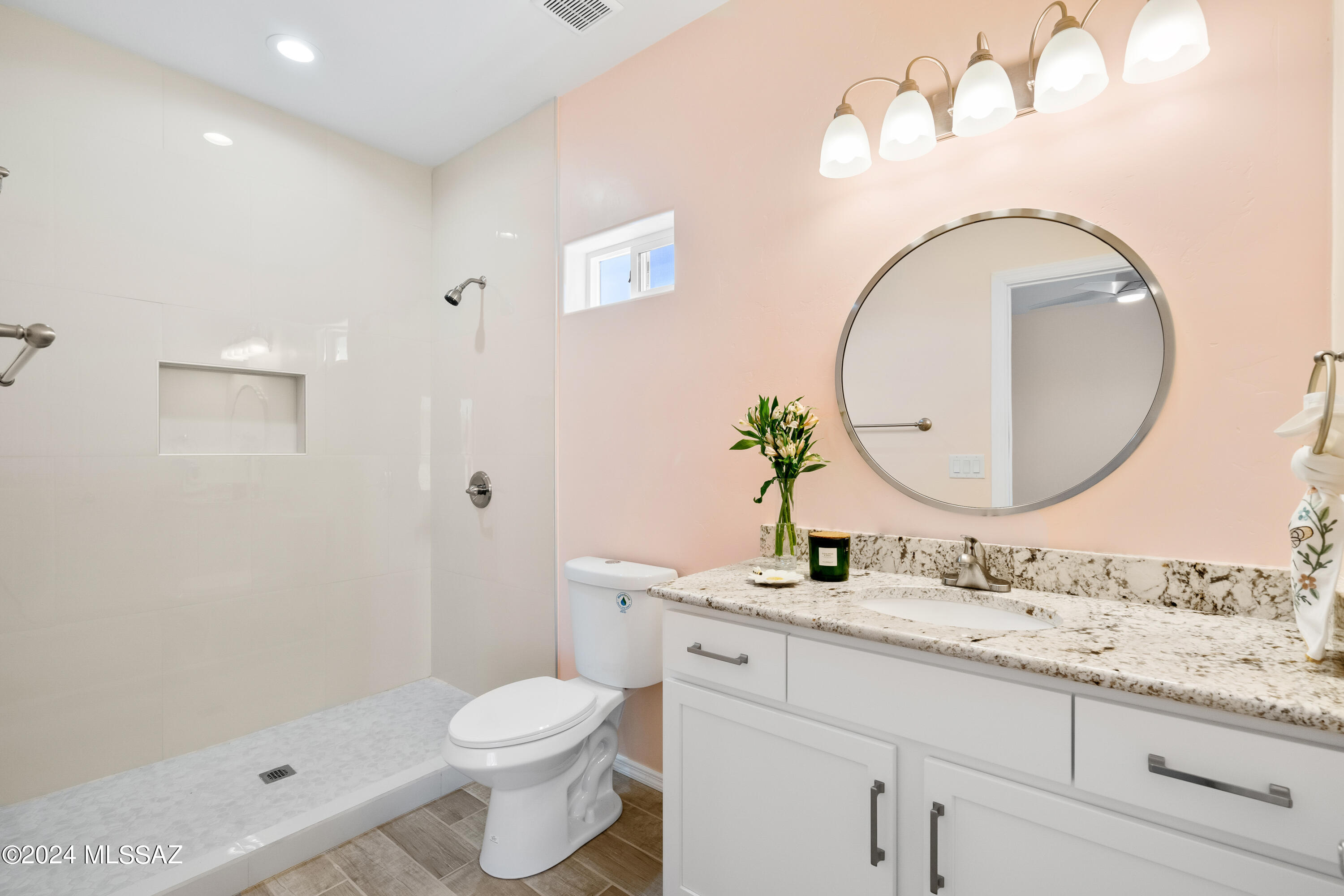 91 Avenida De Las Naciones Rio Rico, AZ 85648 - Photo 14 of 36 a bathroom with a granite countertop toilet sink and mirror