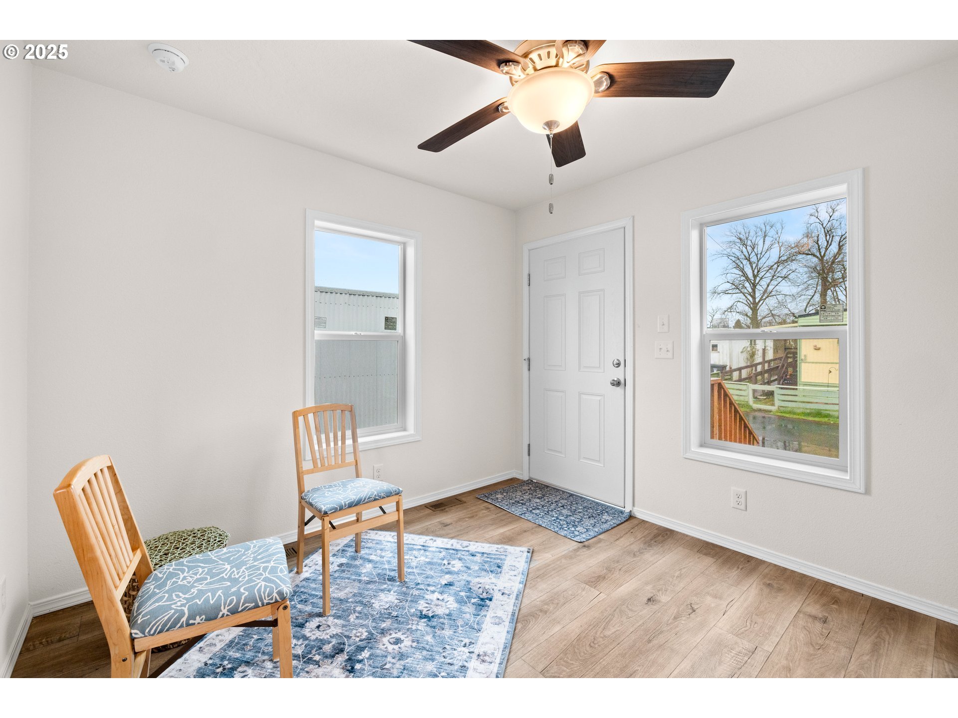 19605 River Road, Unit 88 Gladstone, OR 97027 - Photo 12 of 25 a porch with a dining table and chairs