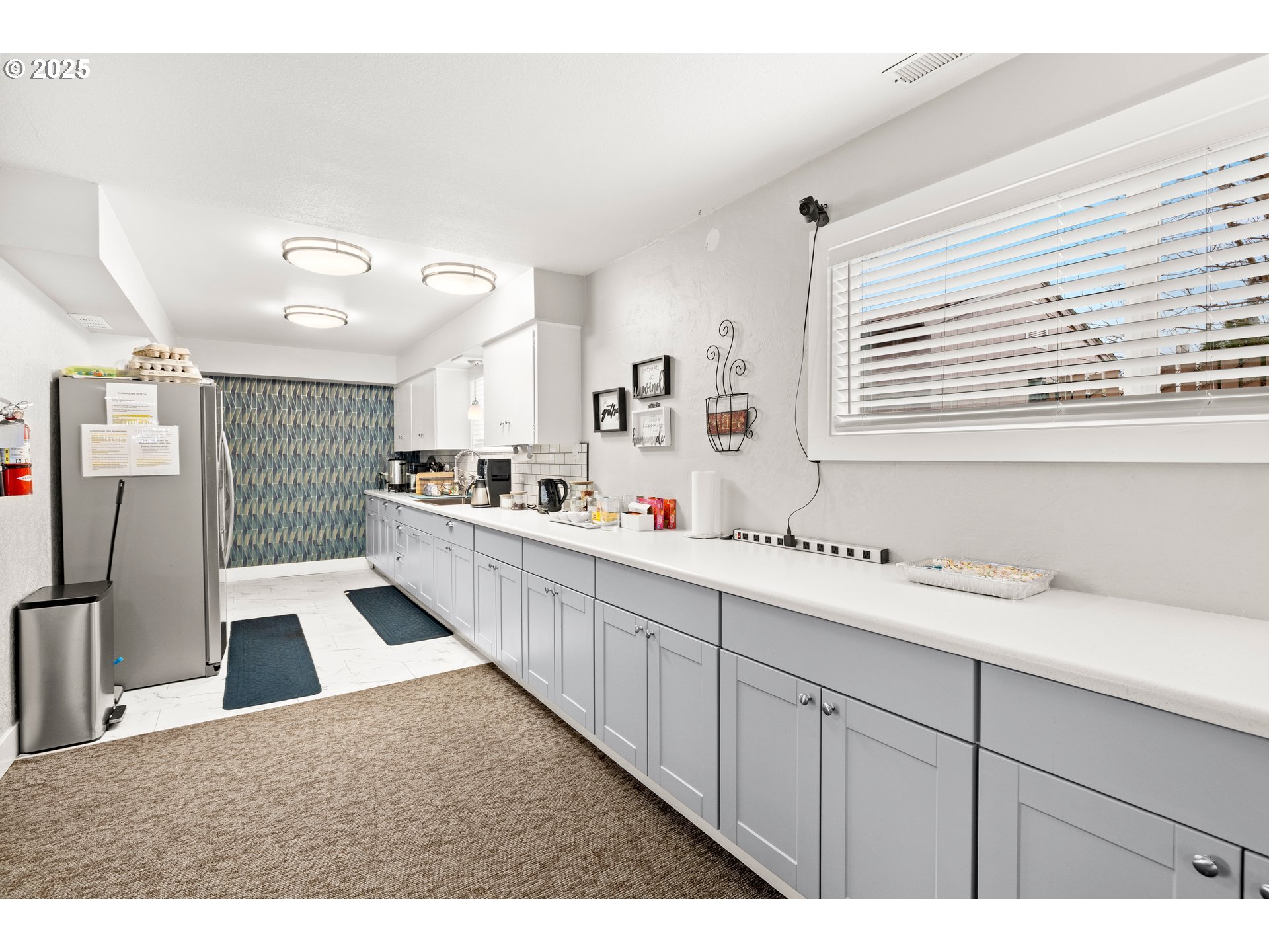 19605 River Road, Unit 88 Gladstone, OR 97027 - Photo 21 of 25 a kitchen with granite countertop a refrigerator a sink and white cabinets