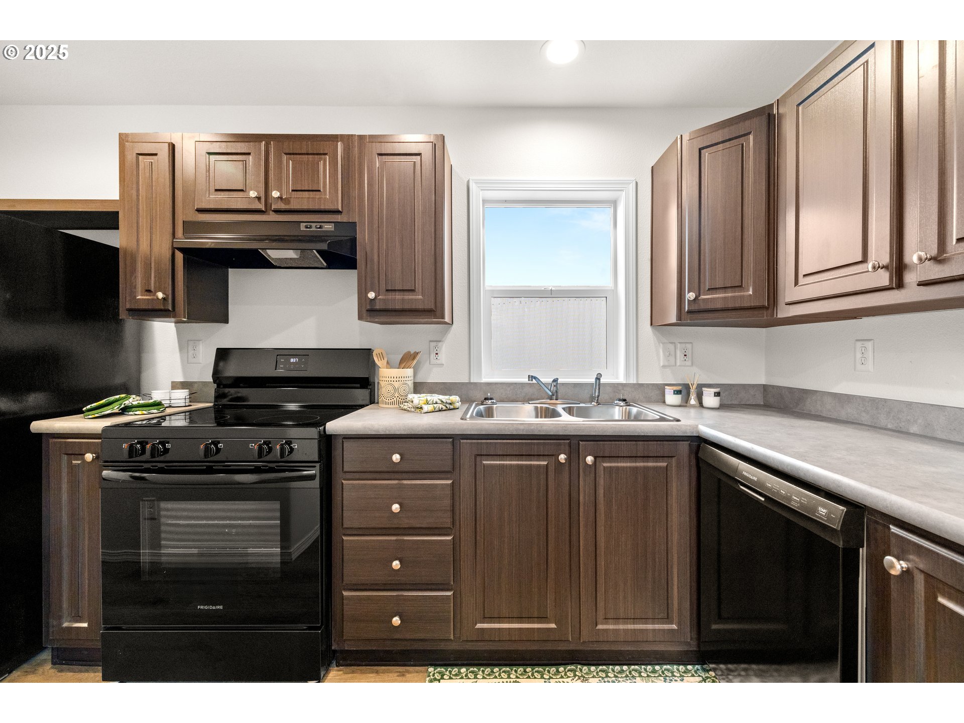 19605 River Road, Unit 88 Gladstone, OR 97027 - Photo 7 of 25 a kitchen with a sink stove top oven and cabinets