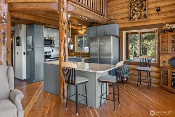 a dining room with furniture and wooden floor