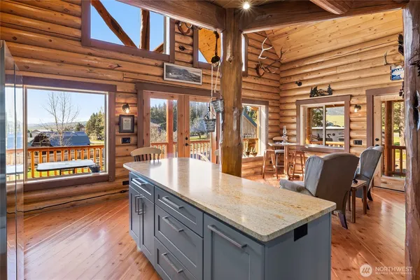 a kitchen with stainless steel appliances granite countertop a stove and cabinets with wooden floor