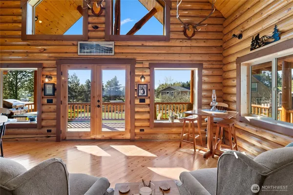 a living room with furniture and large windows