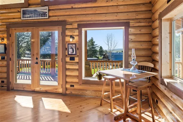 a view of a dining room with furniture large windows and wooden floor