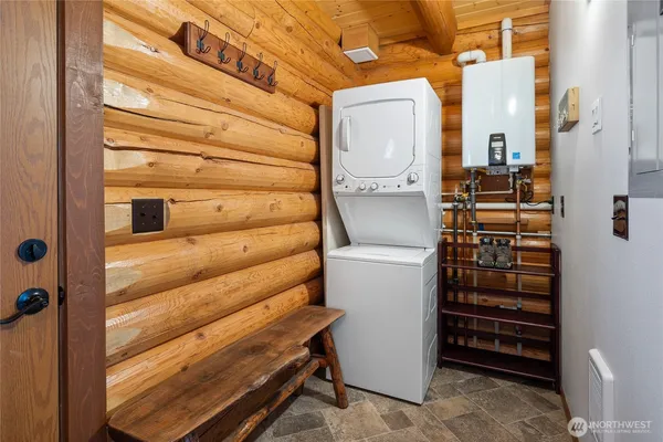 a view of walk in closet and wooden door