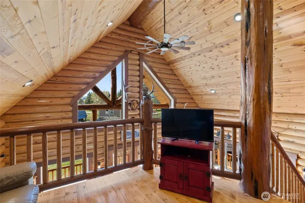a view of a balcony with furniture and wooden floor