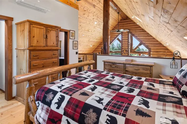 a bed sitting in a bedroom next to a window