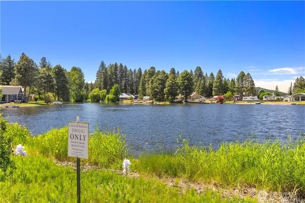 a view of a lake with houses in the back