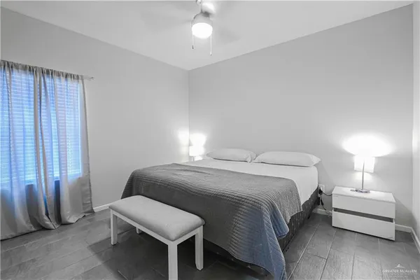 a bedroom with a bed and a lamp