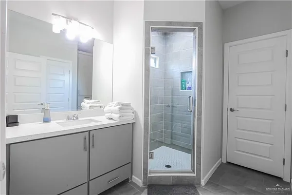 a bathroom with a double vanity sink and mirror
