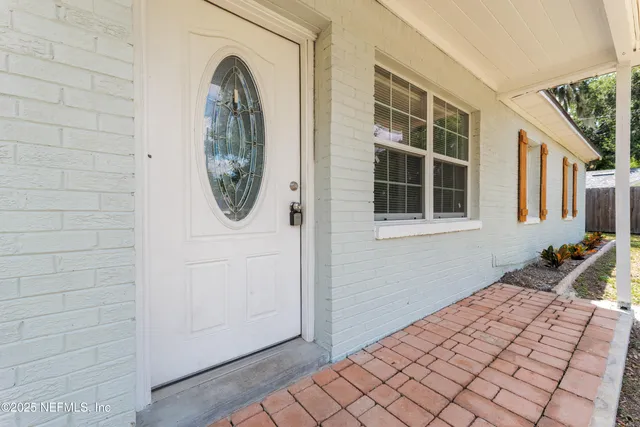 a utility room with dryer and window