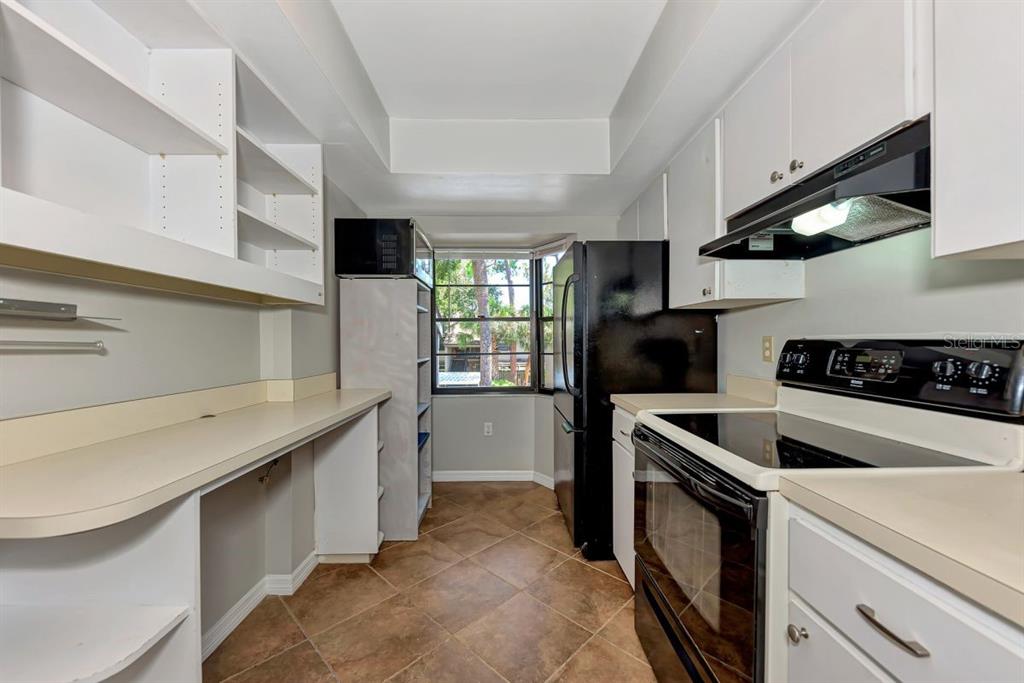 5645 Summerside Lane, Unit 40B Sarasota, FL 34231 - Photo 11 of 23 a kitchen that has a sink and a stove in it