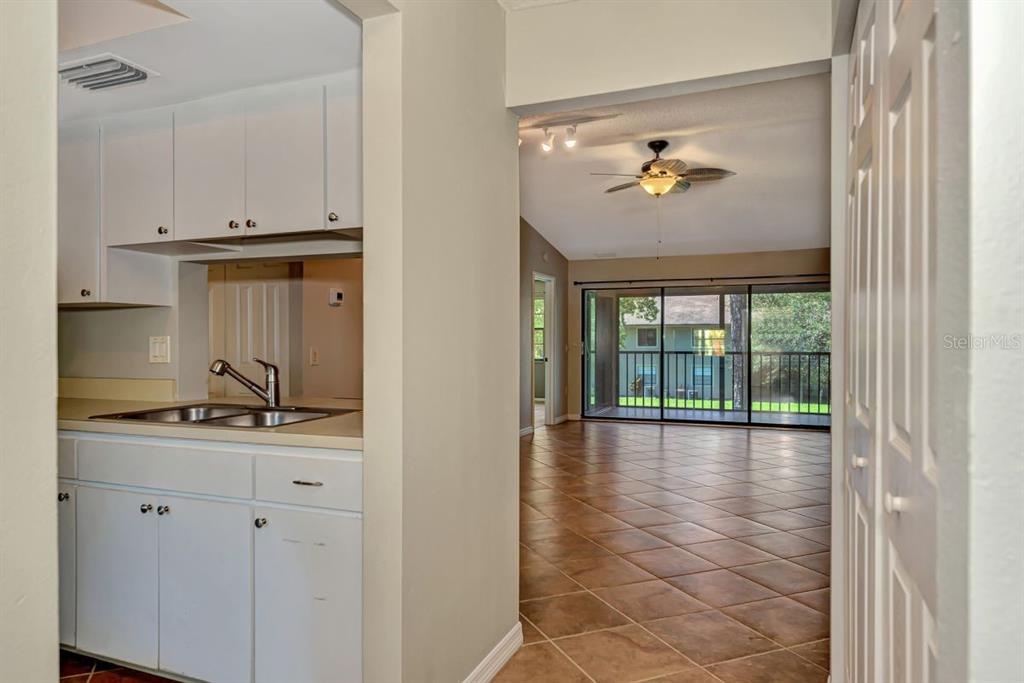 5645 Summerside Lane, Unit 40B Sarasota, FL 34231 - Photo 12 of 23 a view of kitchen with granite countertop cabinets and outdoor space