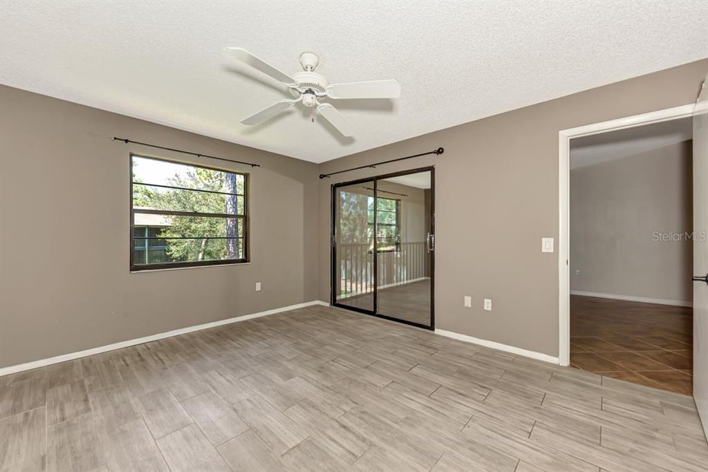 5645 Summerside Lane, Unit 40B Sarasota, FL 34231 - Photo 13 of 23 a view of an empty room with window and wooden floor