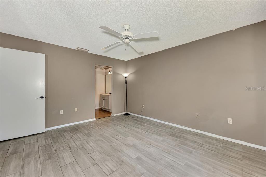 5645 Summerside Lane, Unit 40B Sarasota, FL 34231 - Photo 14 of 23 a view of an empty room with wooden floor