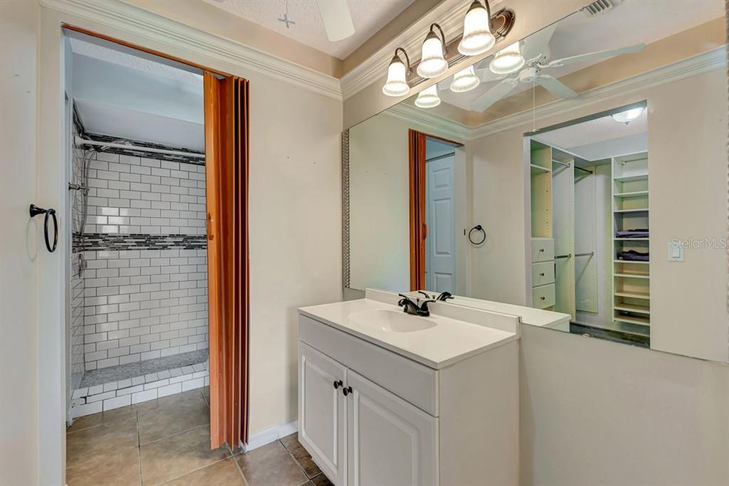 5645 Summerside Lane, Unit 40B Sarasota, FL 34231 - Photo 15 of 23 a bathroom with a sink vanity and mirror