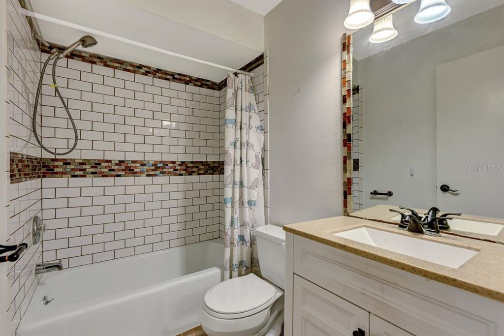 5645 Summerside Lane, Unit 40B Sarasota, FL 34231 - Photo 18 of 23 a bathroom with a sink a toilet and shower