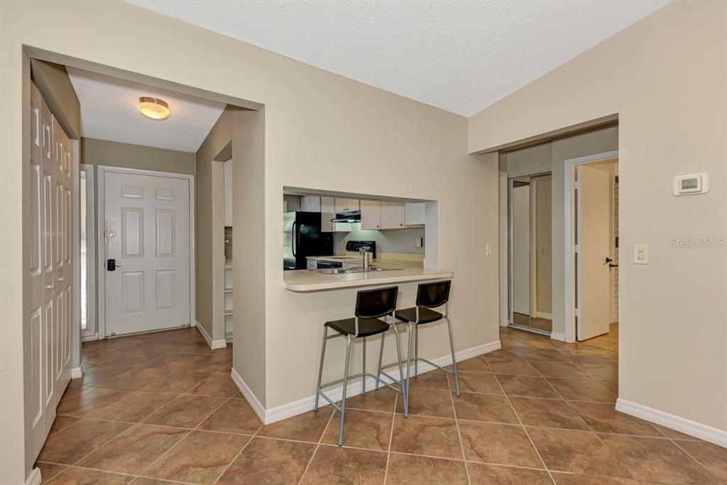 5645 Summerside Lane, Unit 40B Sarasota, FL 34231 - Photo 7 of 23 a view of kitchen with dining area refrigerator and window