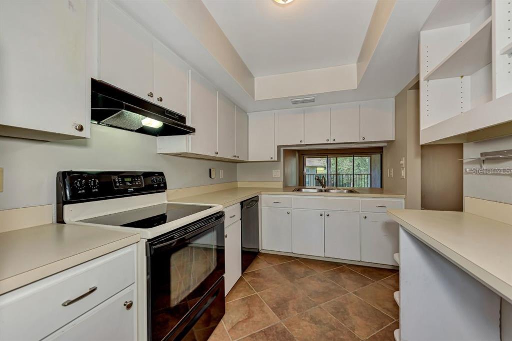 5645 Summerside Lane, Unit 40B Sarasota, FL 34231 - Photo 9 of 23 a kitchen with cabinets and white appliances
