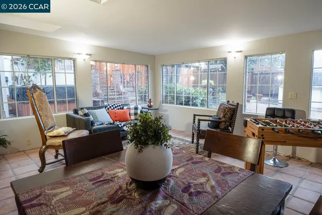 a view of a patio with table and chairs with wooden fence and plants