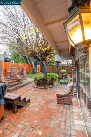 a view of kitchen with sink and refrigerator in wooden floor