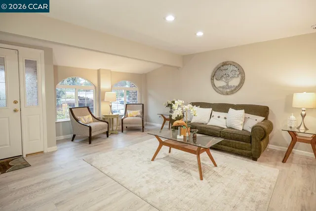 a living room with furniture and a large window