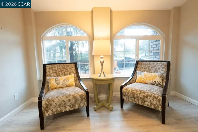 a bedroom with furniture and a large window