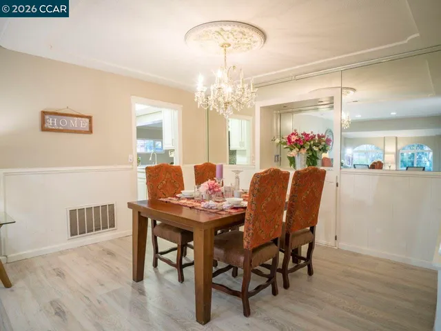 a view of a dining room with furniture and chandelier
