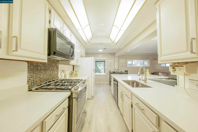 a kitchen that has a lot of cabinets in it