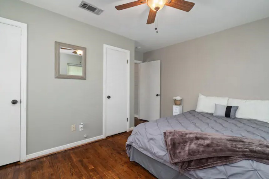 4709 Lido Lane Houston, TX 77092 - Photo 15 of 19 a bedroom with a large bed and a chandelier