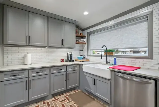 a kitchen with a sink stove and cabinets