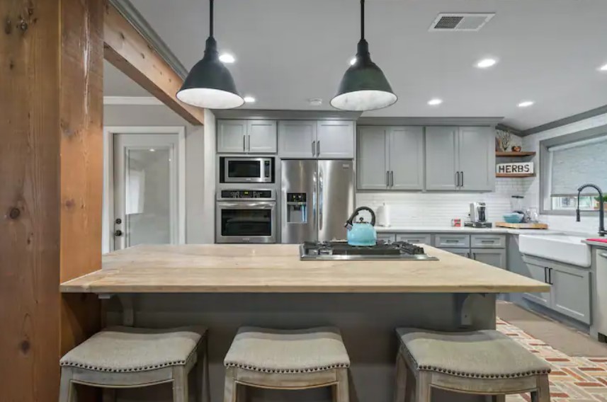 4709 Lido Lane Houston, TX 77092 - Photo 4 of 19 a kitchen with a table chairs microwave and cabinets