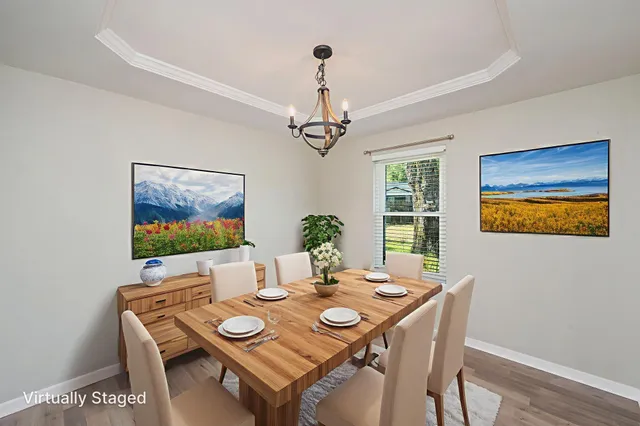 a view of a dining room with furniture wooden floor and a chandelier