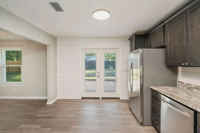 an empty room with wooden floor and a window