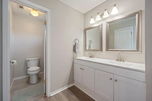 a bathroom with a toilet sink and mirror