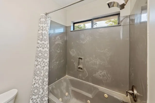 a bathroom with a bathtub and shower